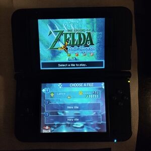 Nintendo 3DS XL with Zelda. Comes w/ charger still has stylus. Mint condition